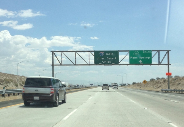 Highway sign reading ‘Indio / other desert cities’